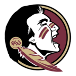 Logo illustration of a Native American chief with face paint, smiling, inside a circular burgundy and gold emblem with a feathered tomahawk crossing behind the head.