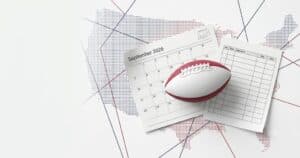 September 2026 calendar with an American football resting on a schedule page against a dotted world-map background.