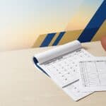 Football and calendars on a desk, suggesting schedule planning for sports events.